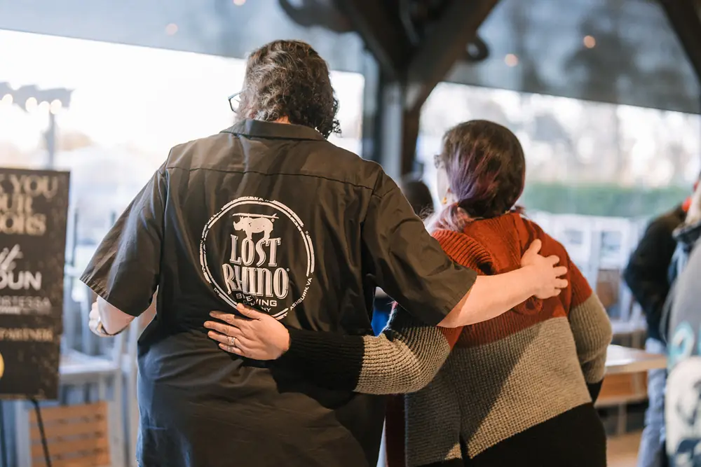 Friends hugging at the Loudoun Beer Awards